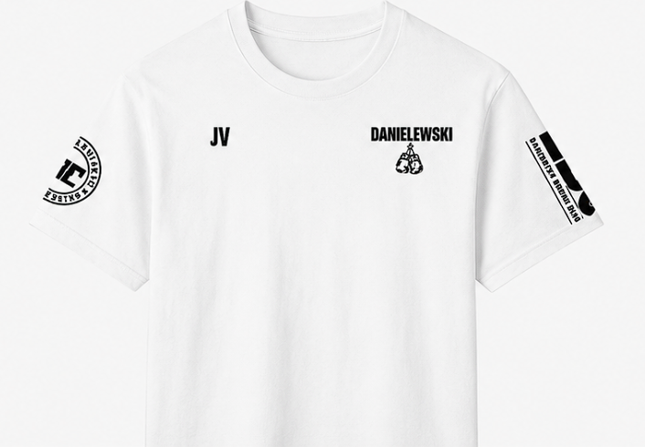 White T-shirt with black text and graphics, including 'JV' and 'DANIELEWSKI' on the front, and various logos on the sleeves.