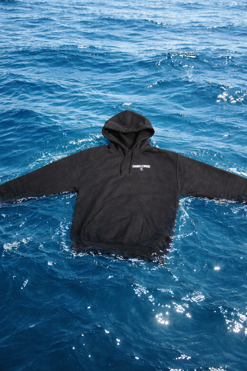 A black hoodie floating in the ocean.