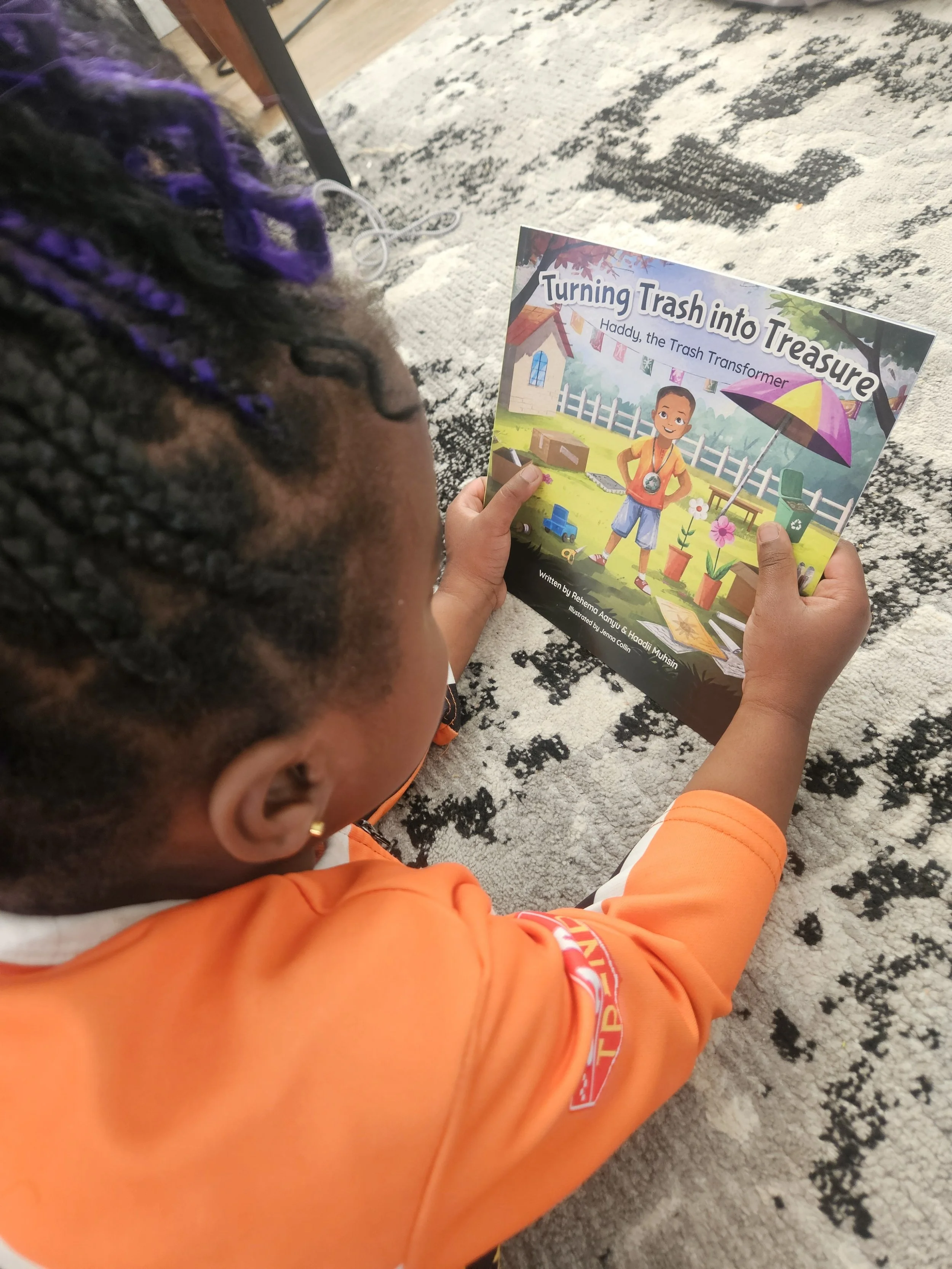 Reading Turning Trash Into Treasure; Haddy the Trash Transformer, a children's book by Rehema Aanyu & Haadii Muhsin