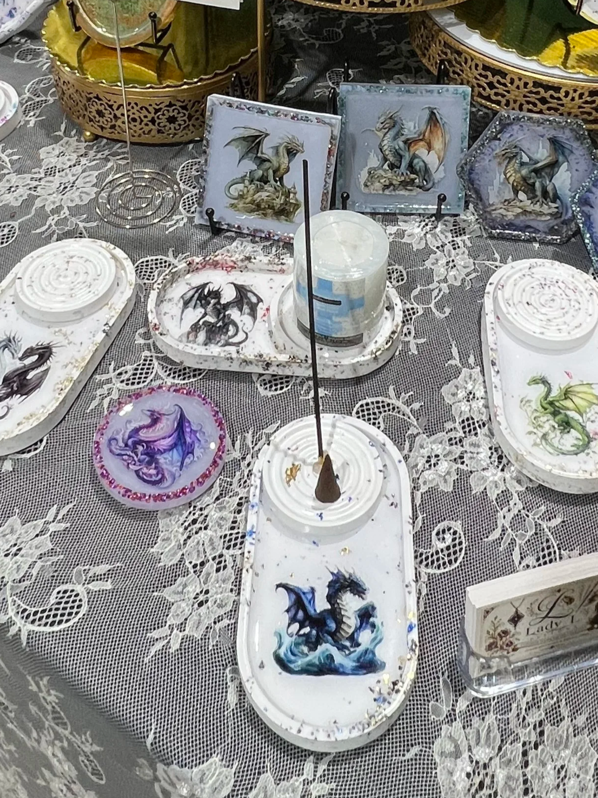Display of decorative dragon-themed trays and incense burners.