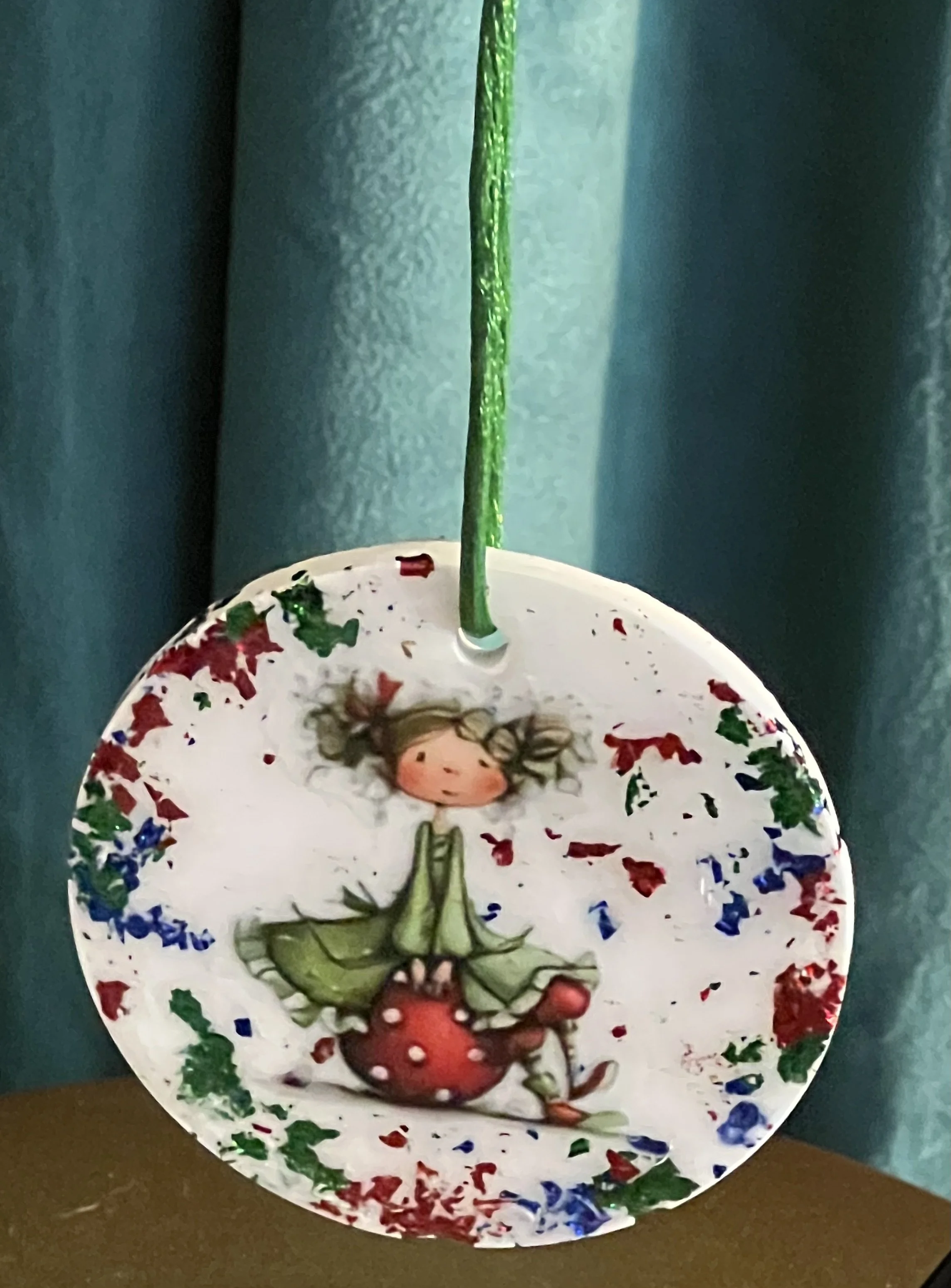 Whimsical Holiday Fairy Sitting On An Ornament