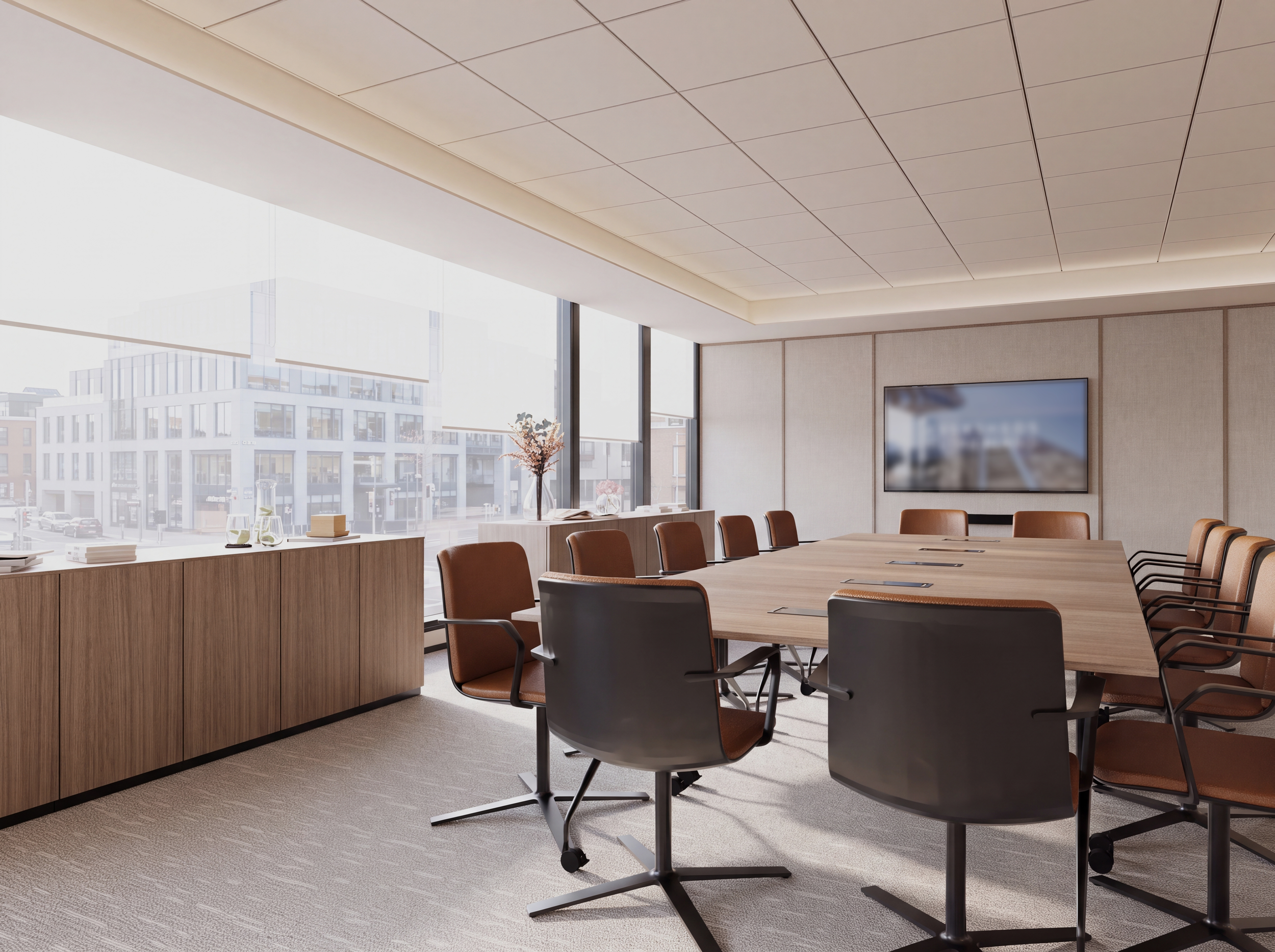 Modern conference room with large windows, a wooden table surrounded by brown and black chairs, a wall-mounted TV, and a sideboard with decorative items like flowers and books.