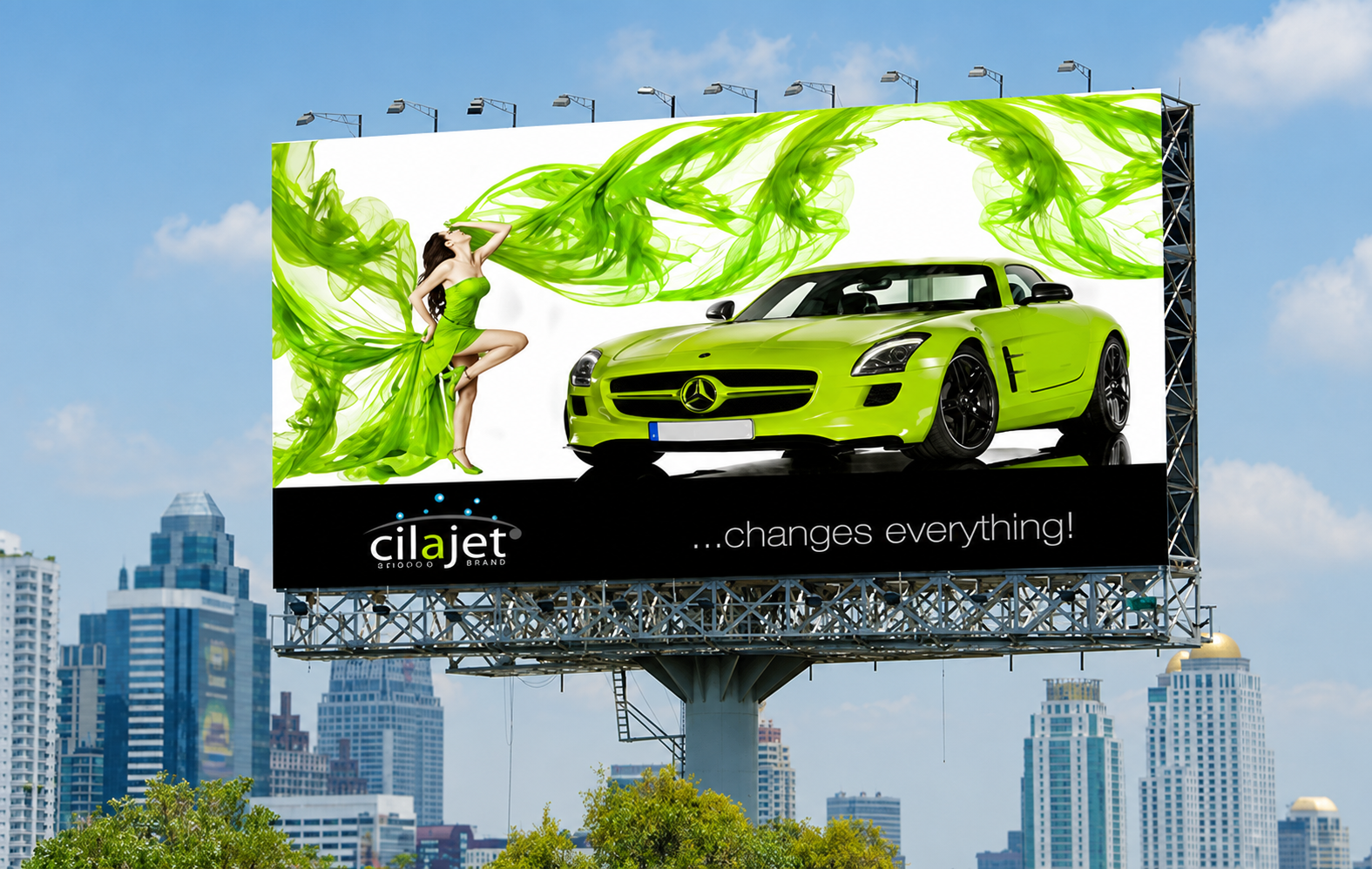 Billboard featuring a green Mercedes-Benz sports car and a woman in a green dress with flowing green fabric, with city skyscrapers in the background, advertising the cilajet brand with the slogan '...changes everything!'