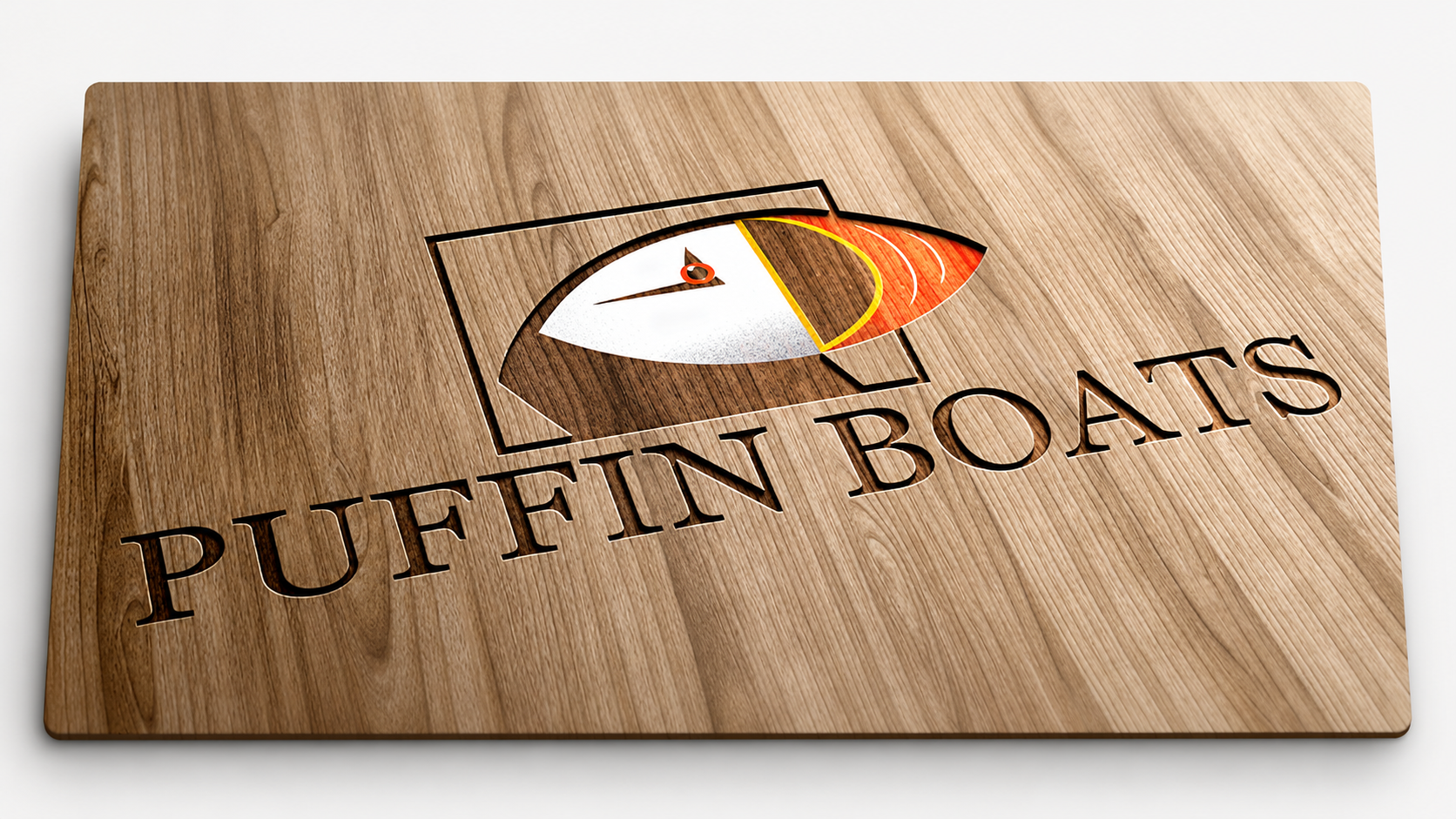 Wooden puzzle piece with a puffin bird illustration and the words "PUFFIN BOARDS" engraved, featuring a puffin's head in profile with colorful beak and eye.