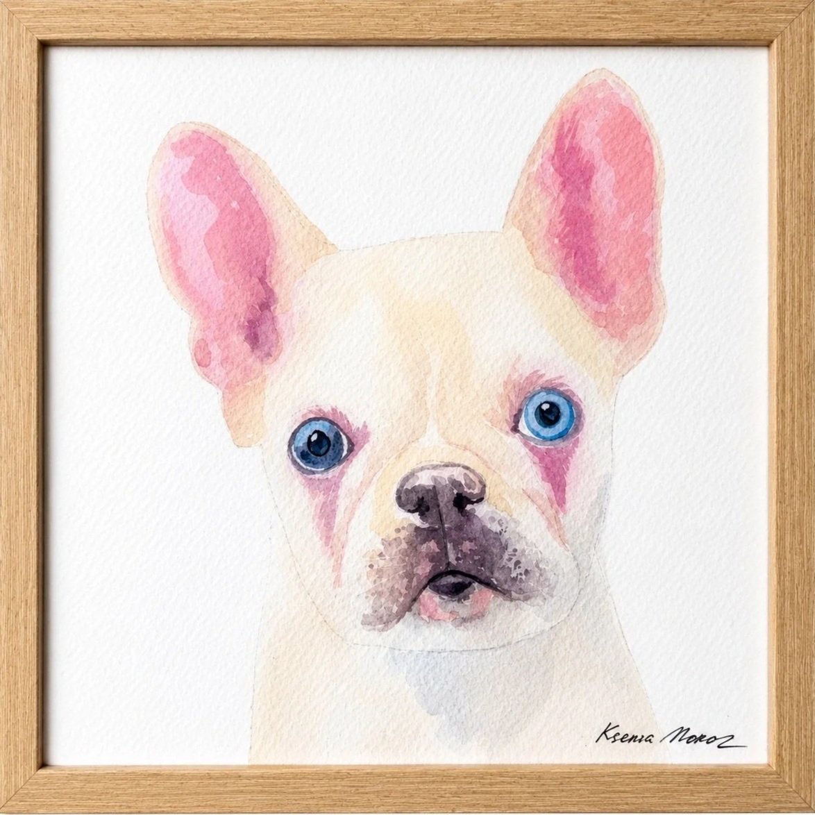 Watercolor painting of a French Bulldog puppy with beige and pinkish ears and bright blue eyes, framed in a wooden frame.