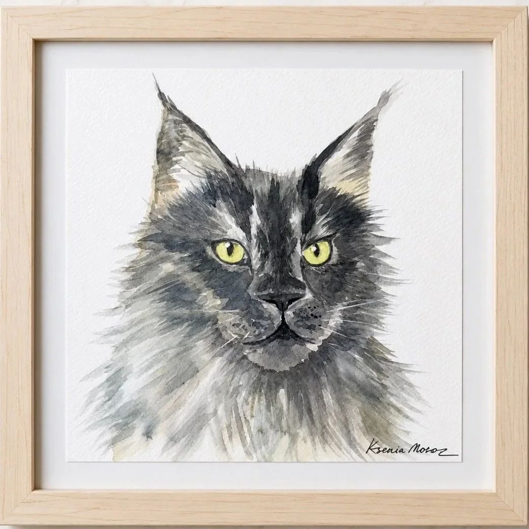 Watercolor painting of a gray tabby cat with yellow eyes, framed with a light wood frame.