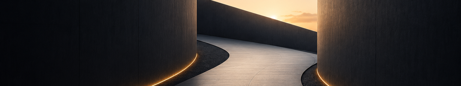A curved walkway between two tall, dark walls with integrated lighting, leading toward a sunset sky.