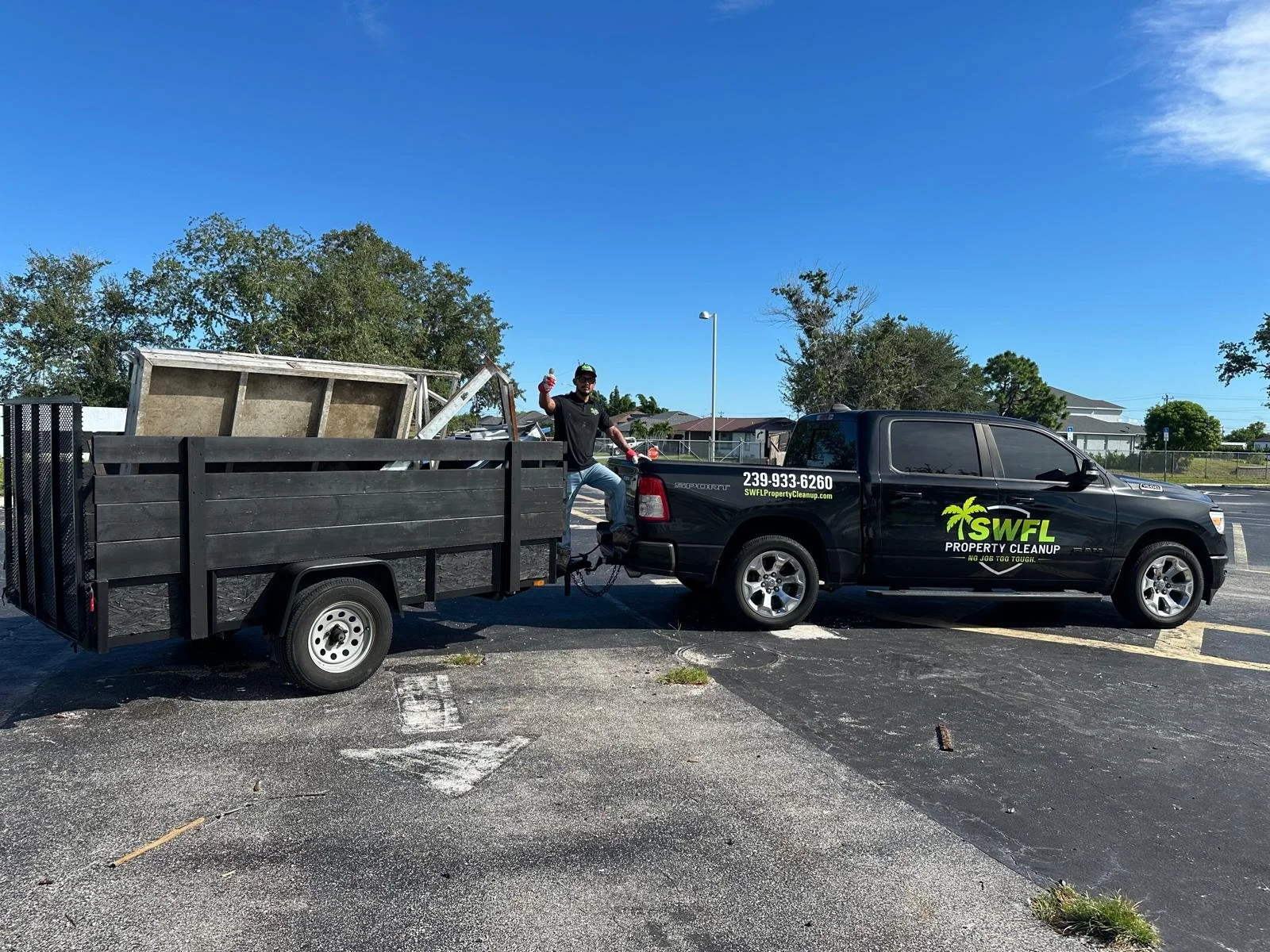 SWFL Property Cleanup truck and trailer loaded during a junk removal job in Southwest Florida