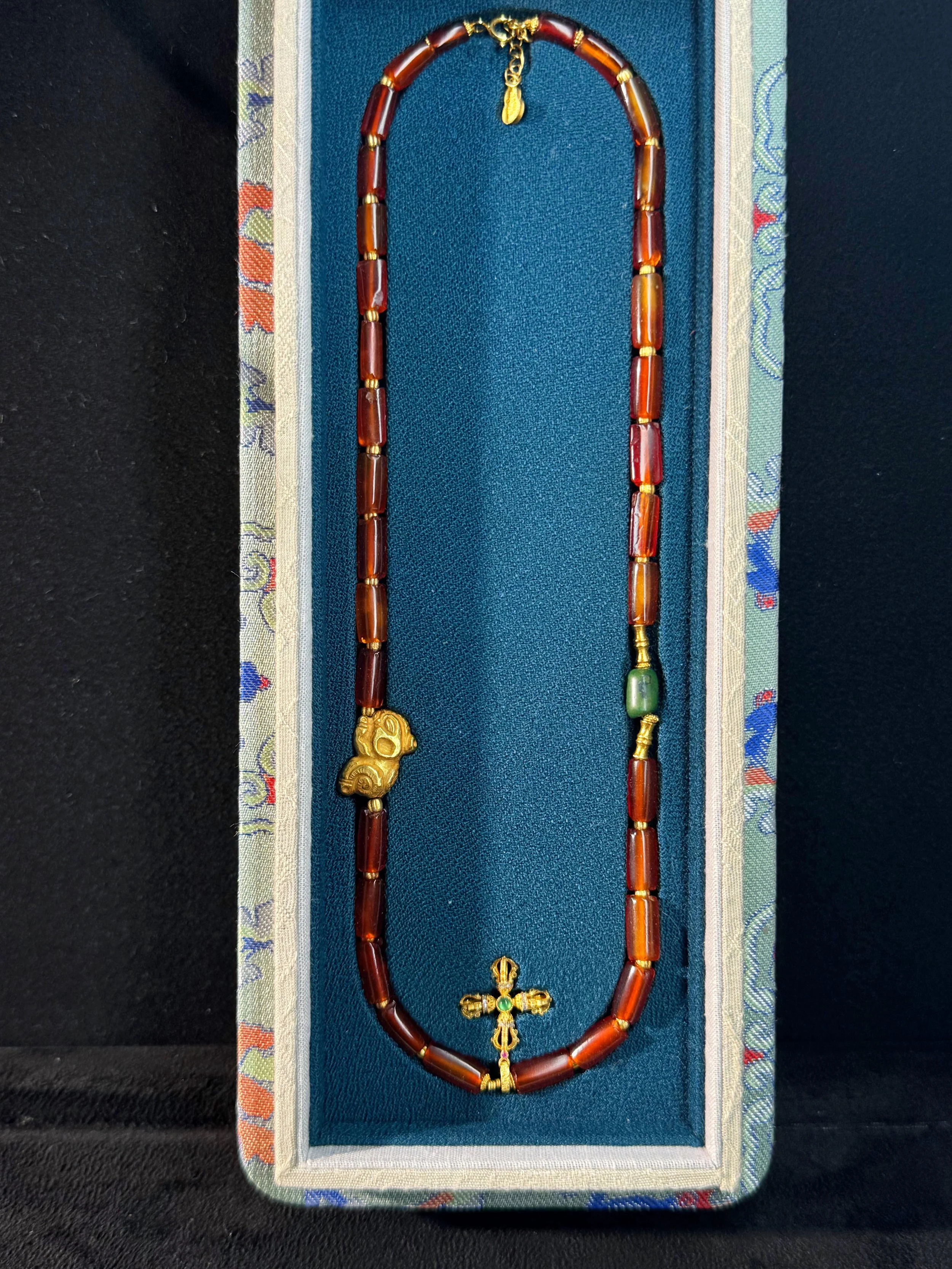 necklace w gold Persimmon Calyx Motif bo x.jpg