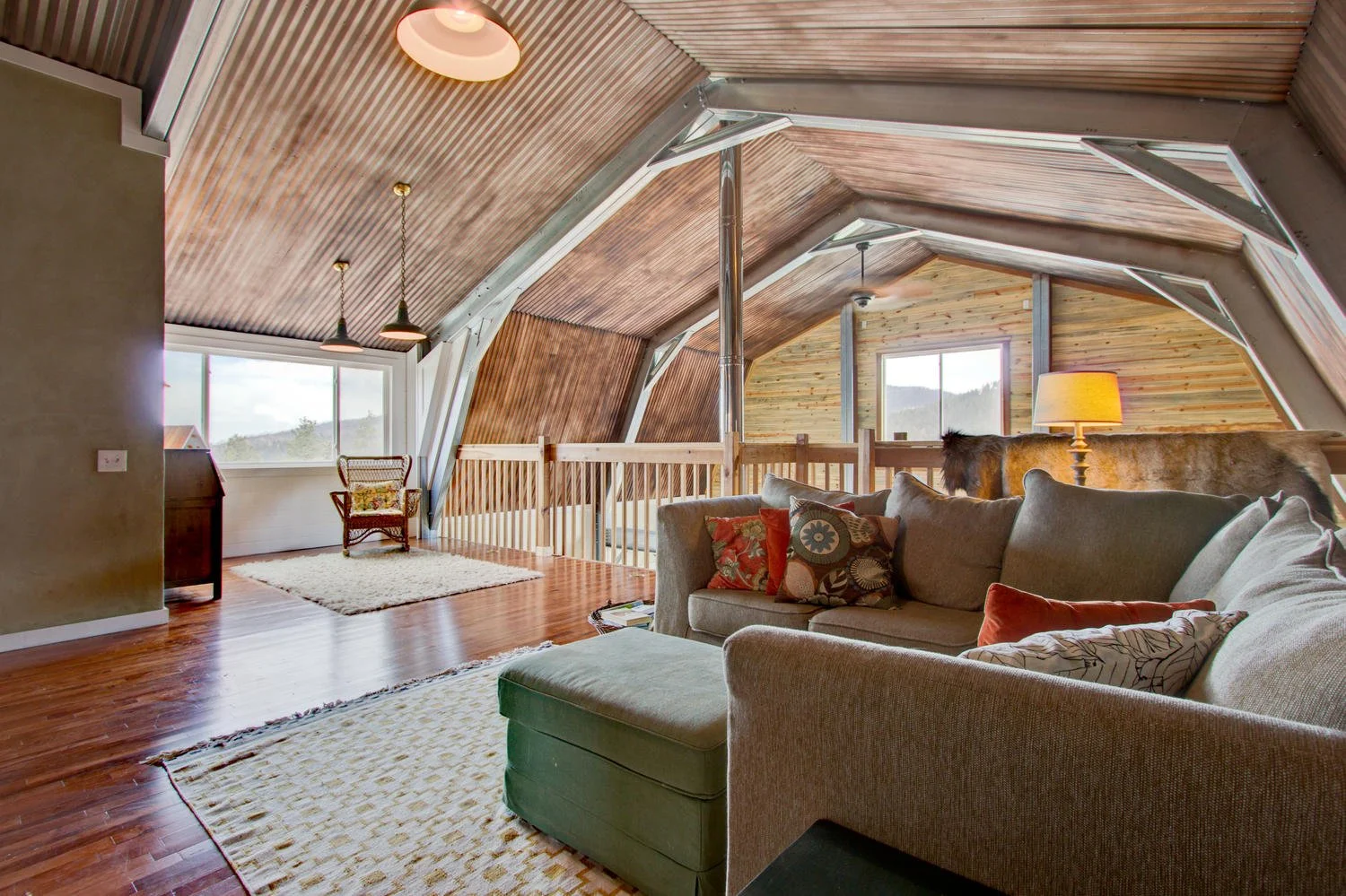 Gambrel style made into a home, this is the second floor with exposed columns and rafters.