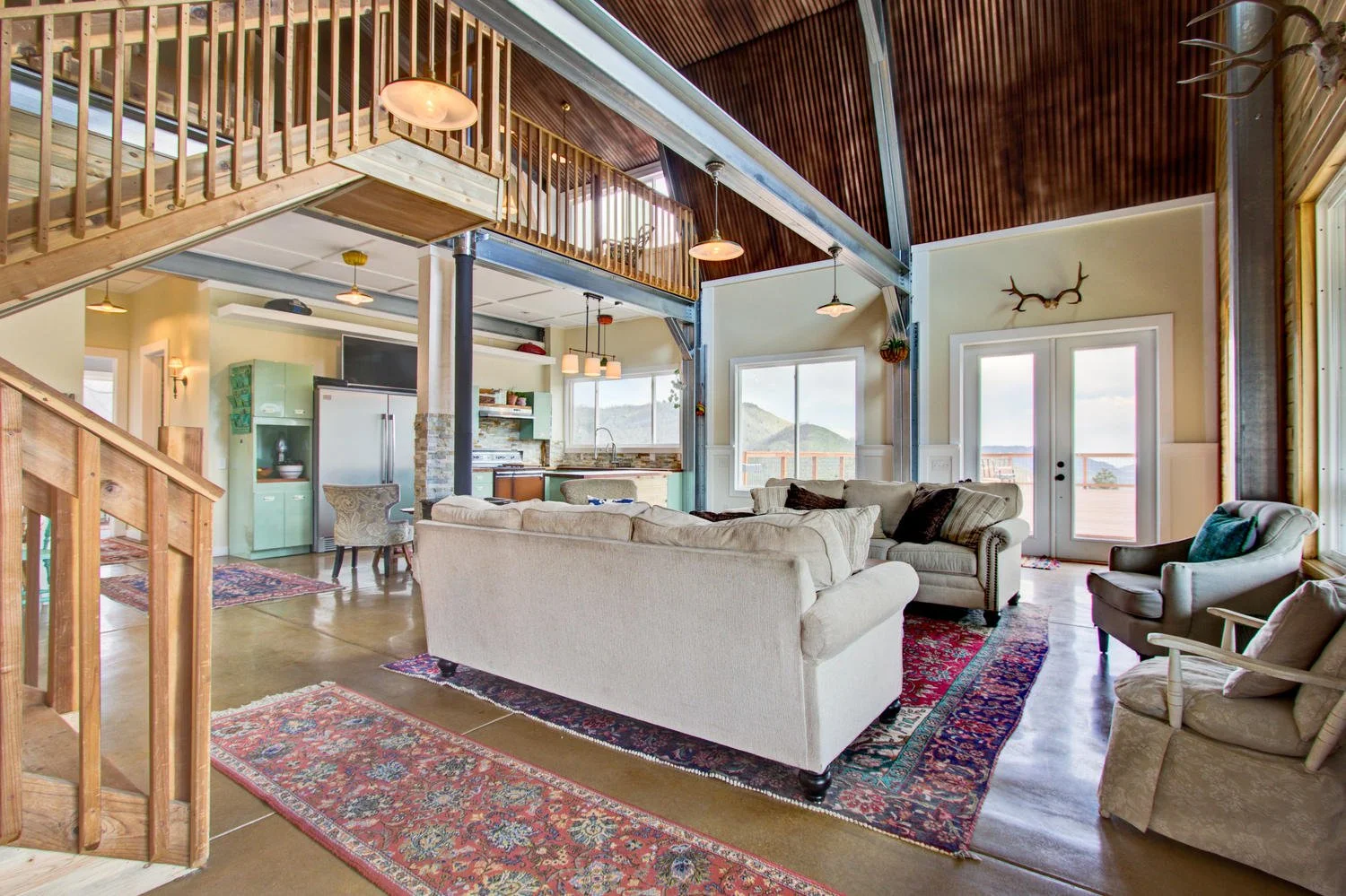 Gambrel style made into a home, this is the first floor with exposed columns and rafters.