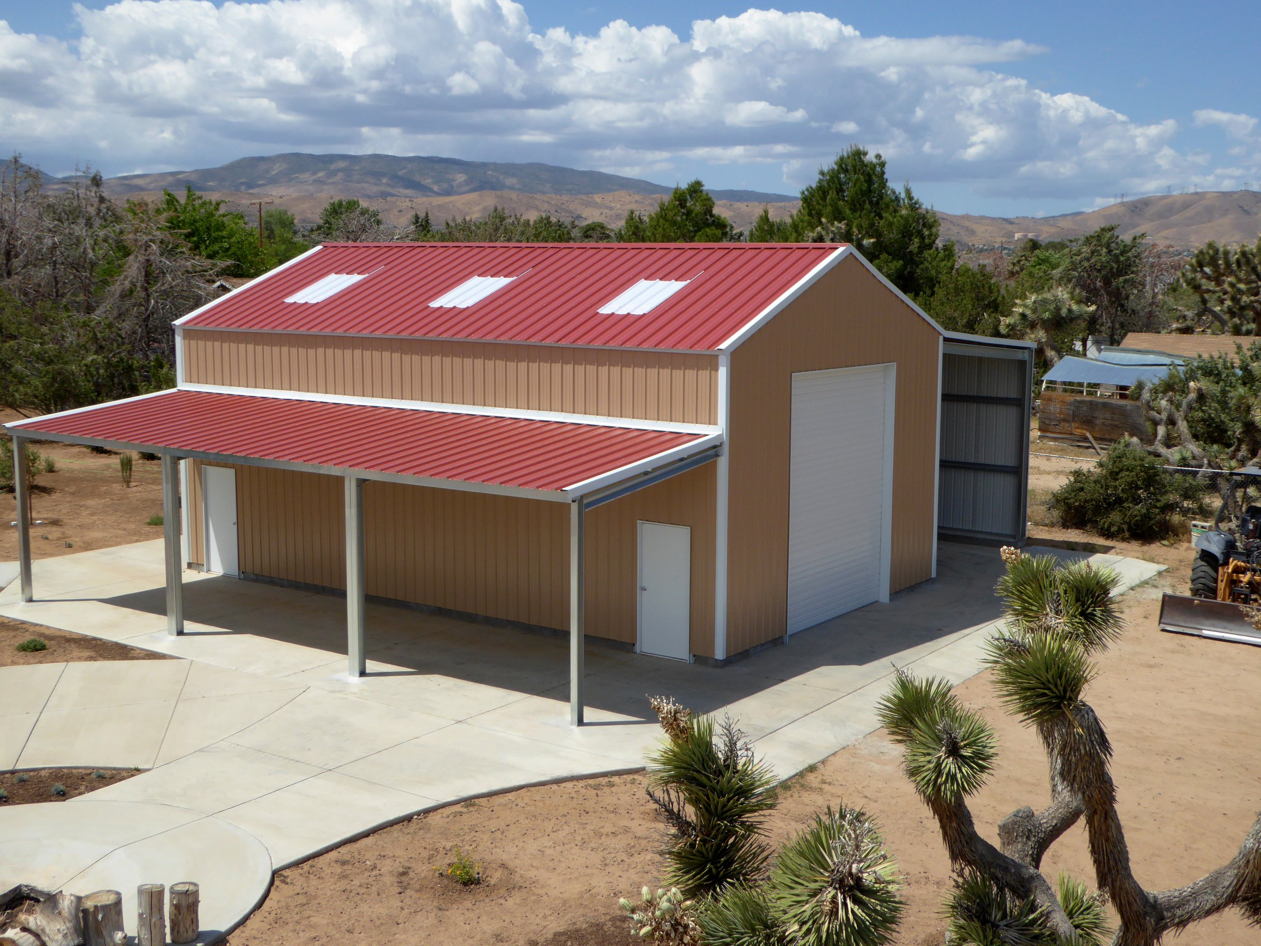 Mechanics shop metal building with RV drive through and a lean to porch.
