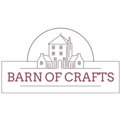 Logo featuring a line drawing of a large house with a chimney, trees, and a semi-arched skyline, with the text "BARN OF CRAFTS" below.