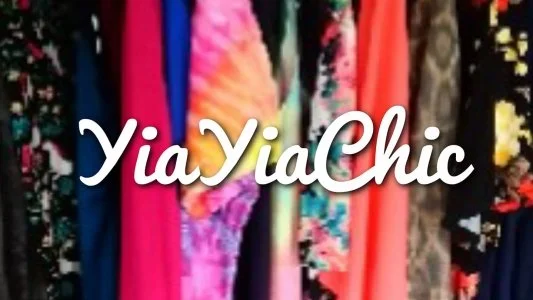 A display of colorful fabric and clothing with the text 'YiaYiaChic' overlayed