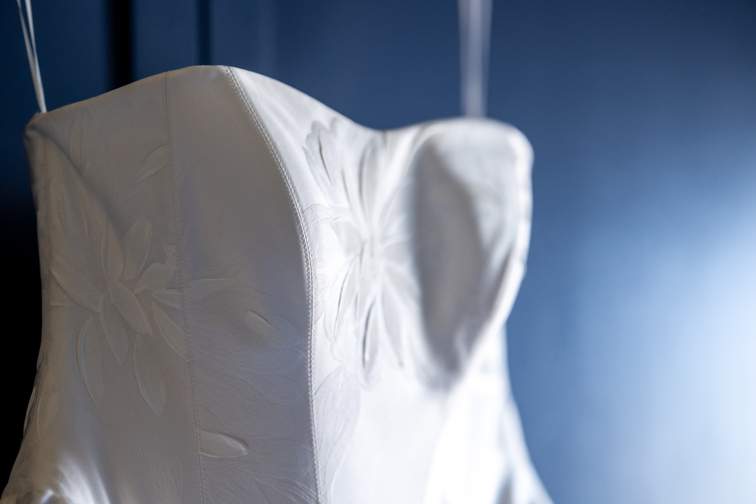 Bride's wedding gown illuminated by soft natural window light at Delamar Mystic