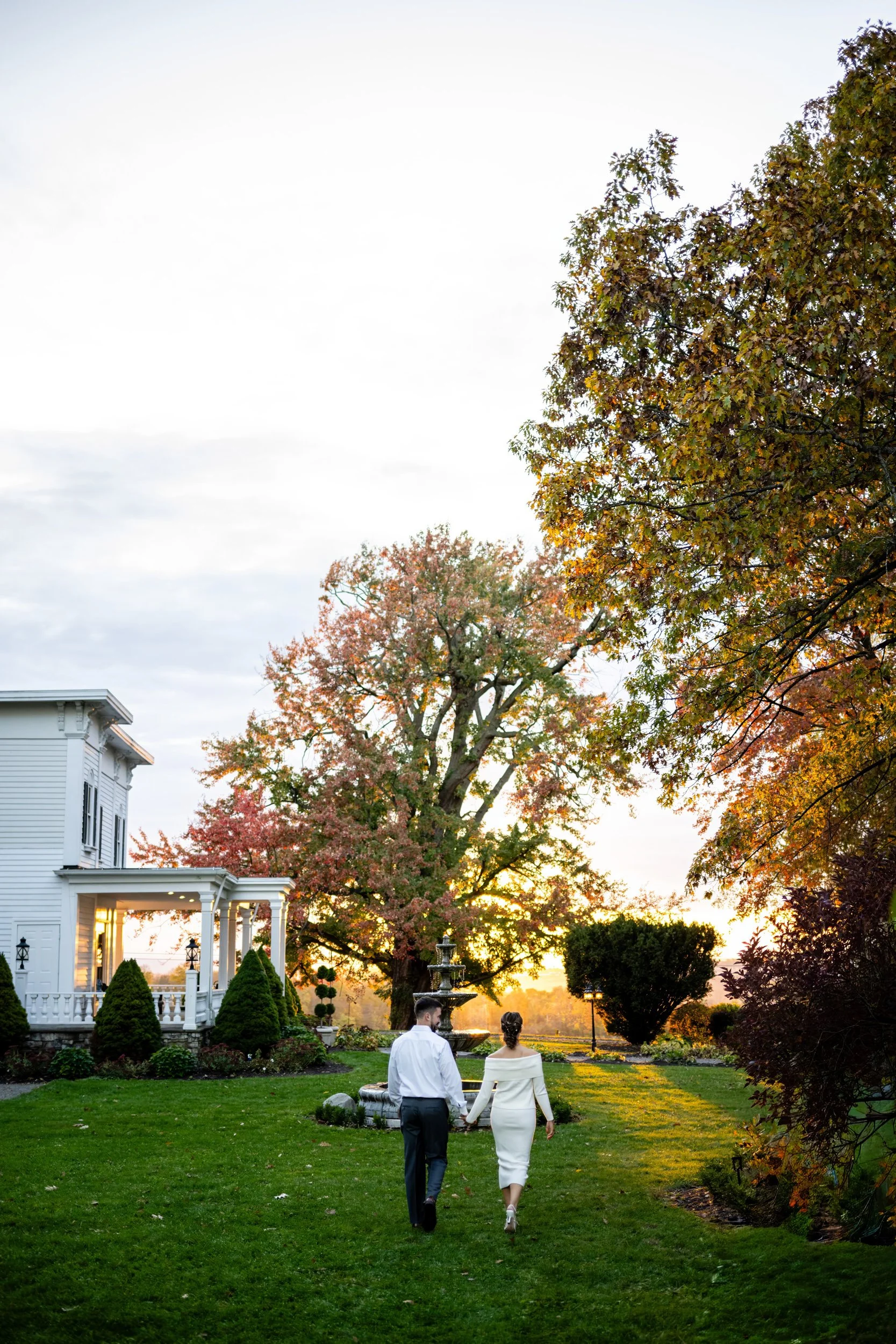 Bride and groom laughing together during rehearsal dinner toasts at The John Joseph Inn in Groton, New York. Event photography by Allison Mott of Mott Collective.