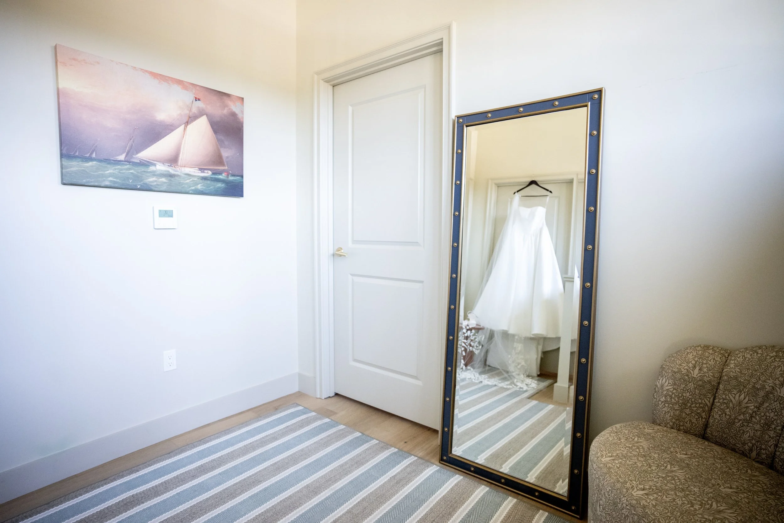 Full-length wedding dress showing extended train on the suite floor at Delamar Mystic