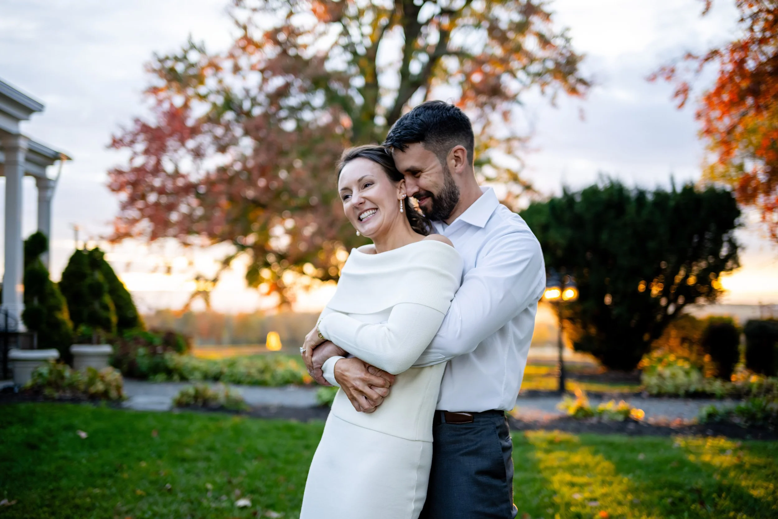 Newlyweds mingling with guests at an outdoor rehearsal dinner gathering on the grounds of The John Joseph Inn near Ithaca, NY. Photo by Mott Collective.