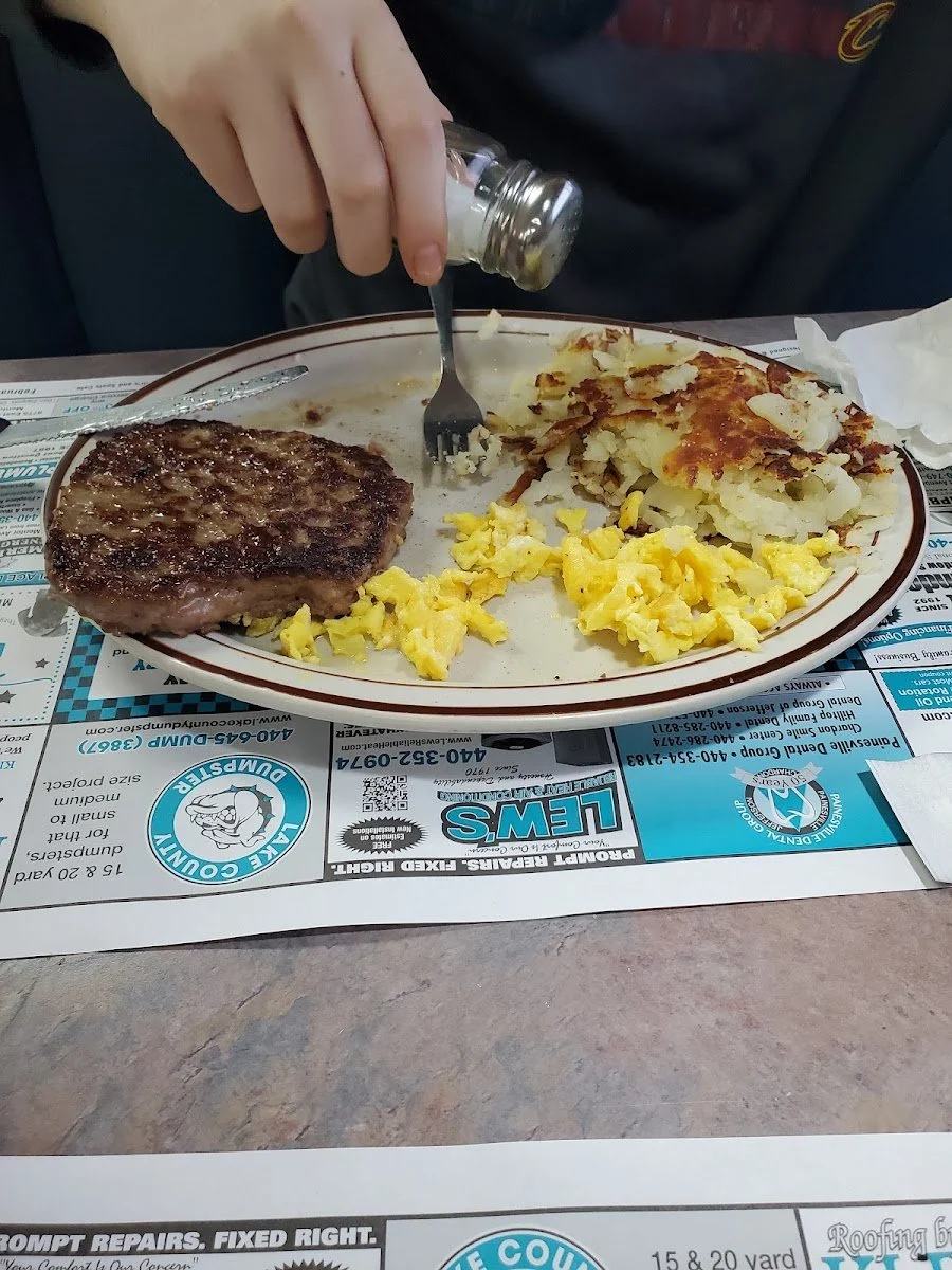 Plate with grilled steak, scrambled eggs, and hash browns.