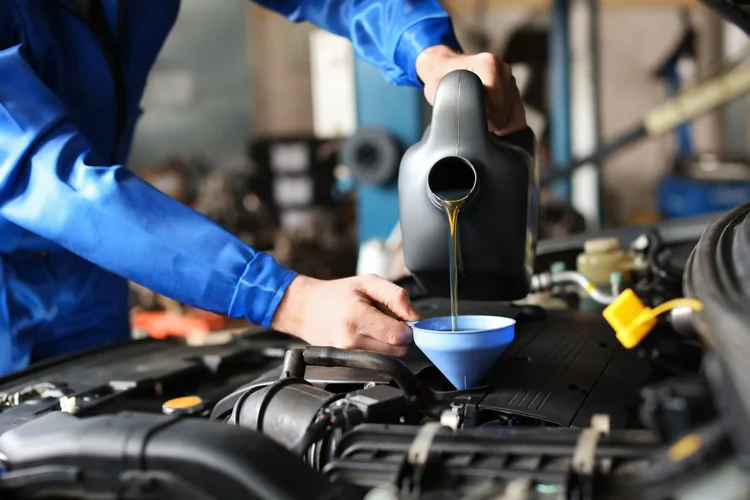 Mobile oil change service at a customer vehicle