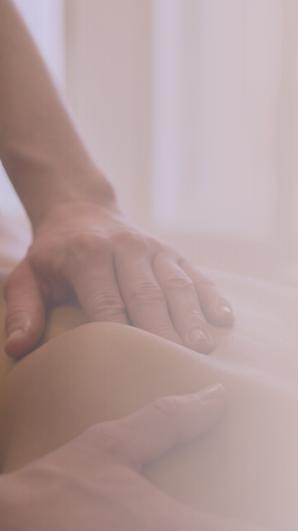 A person receiving a massage on their back from Julie, owner of Ember & Flow; LGBTQIA+ friendly massage therapist in South Denver.