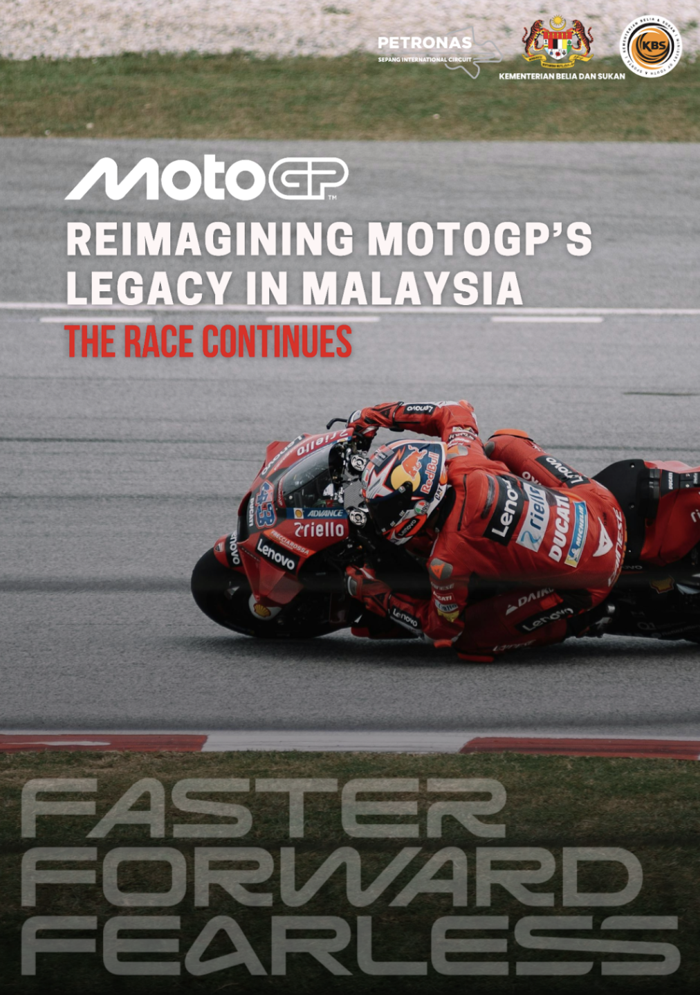 A motorcycle racer in red racing gear and helmet leaning into a turn on a racetrack, surrounded by green grass and gray asphalt, promoting MotoGP's legacy in Malaysia.