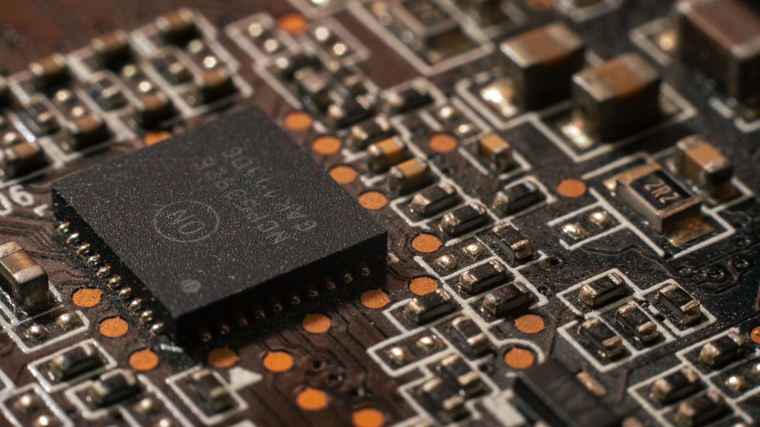 Close-up of a computer circuit board with an integrated chip and various electronic components.