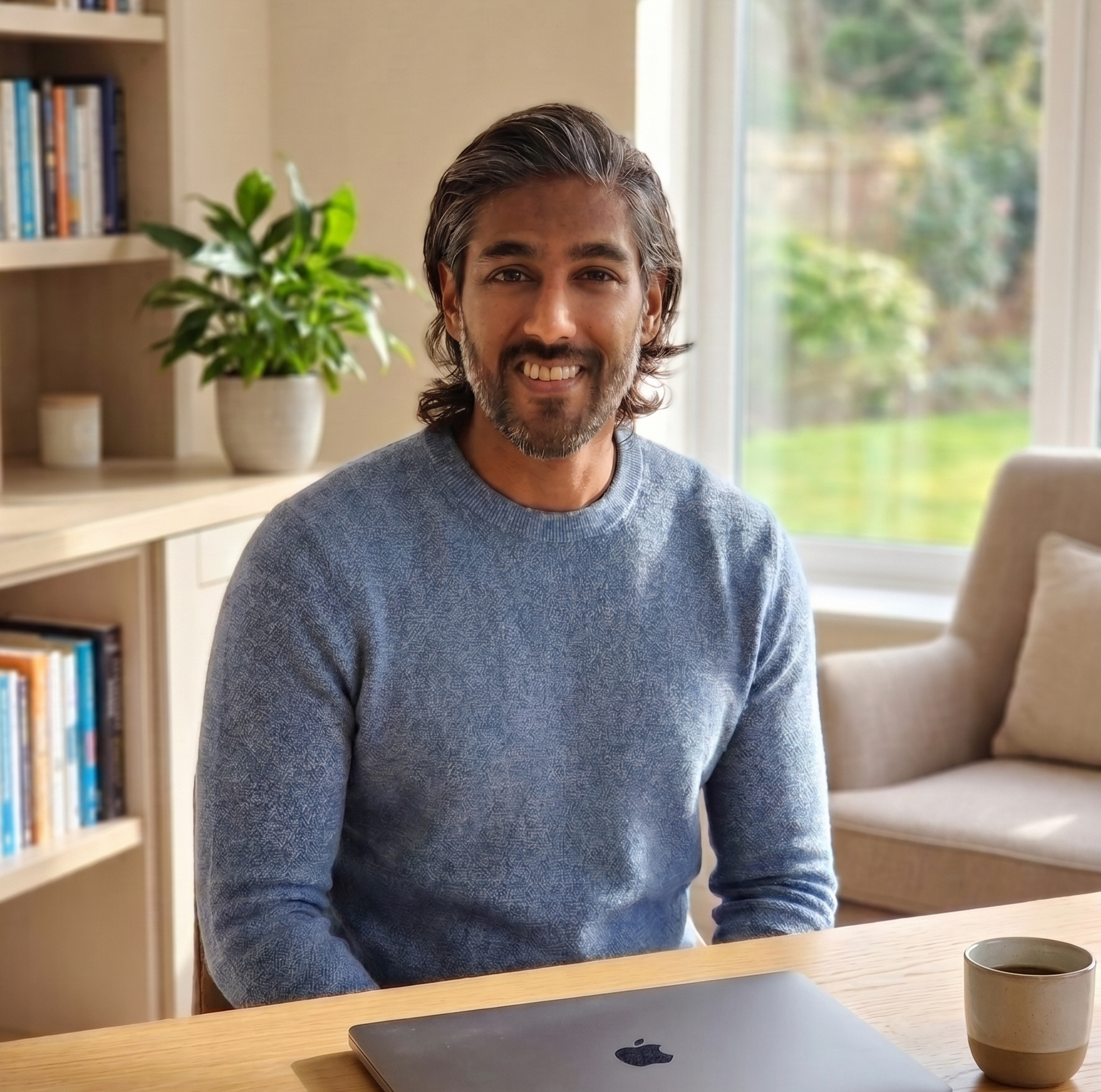 A friendly man smiling at the camera ready to explain his background about financial investing