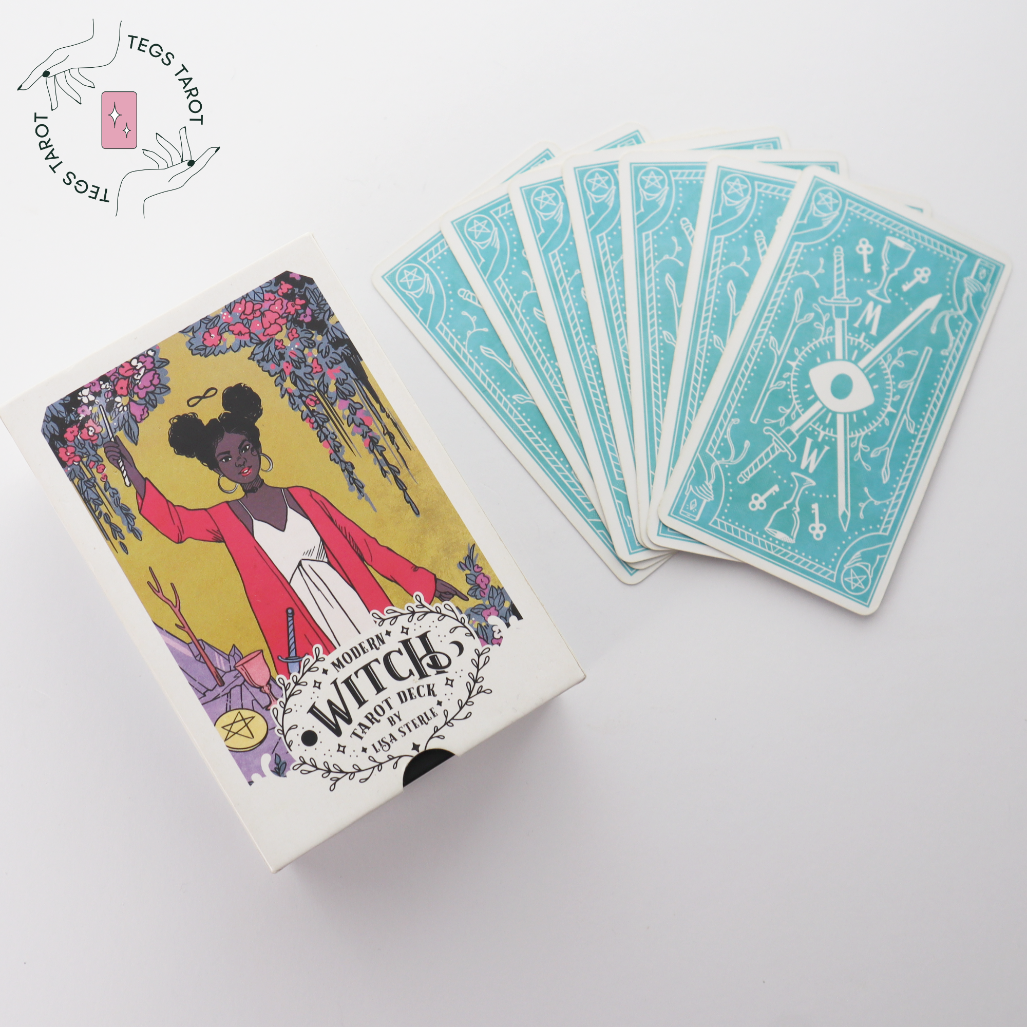 Modern Witch Tarot by Lisa Sterle deck cover with fanned out cards from the deck placed to the side.