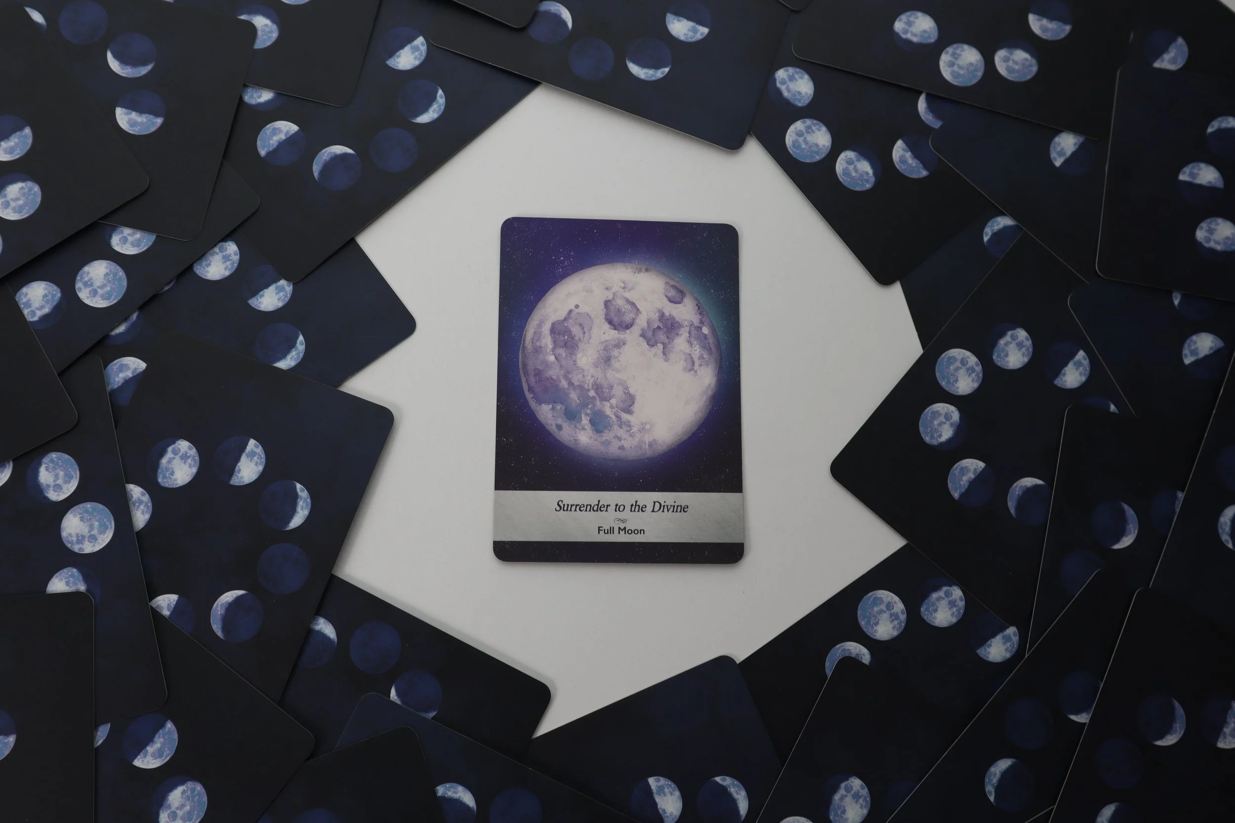 Cards from the Moonology Oracle Deck are face down around the boarder, with a clear space and a single card in the centre. The Centre card is the Full Moon Card with the advice to 'Surrender to the Divine'