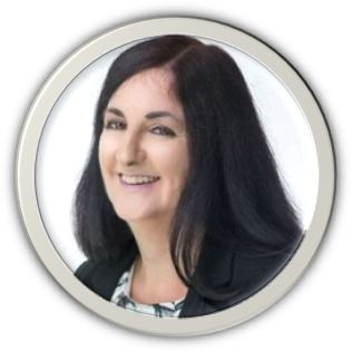 A woman with shoulder-length black hair smiling at the camera, wearing a black blazer and white blouse, against a white background.