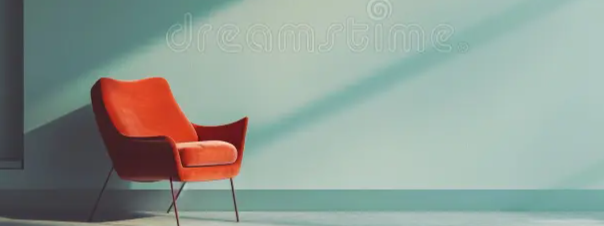 A red and orange armchair with a mid-century modern style against a plain, light-colored wall.
