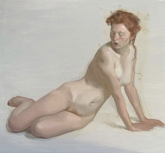 Nude woman with red hair reclining on a white surface with a plain background.