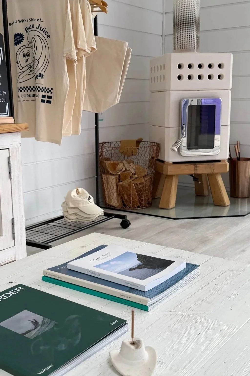 Shared interior at the Peak retreat house with towels and a wood burner.