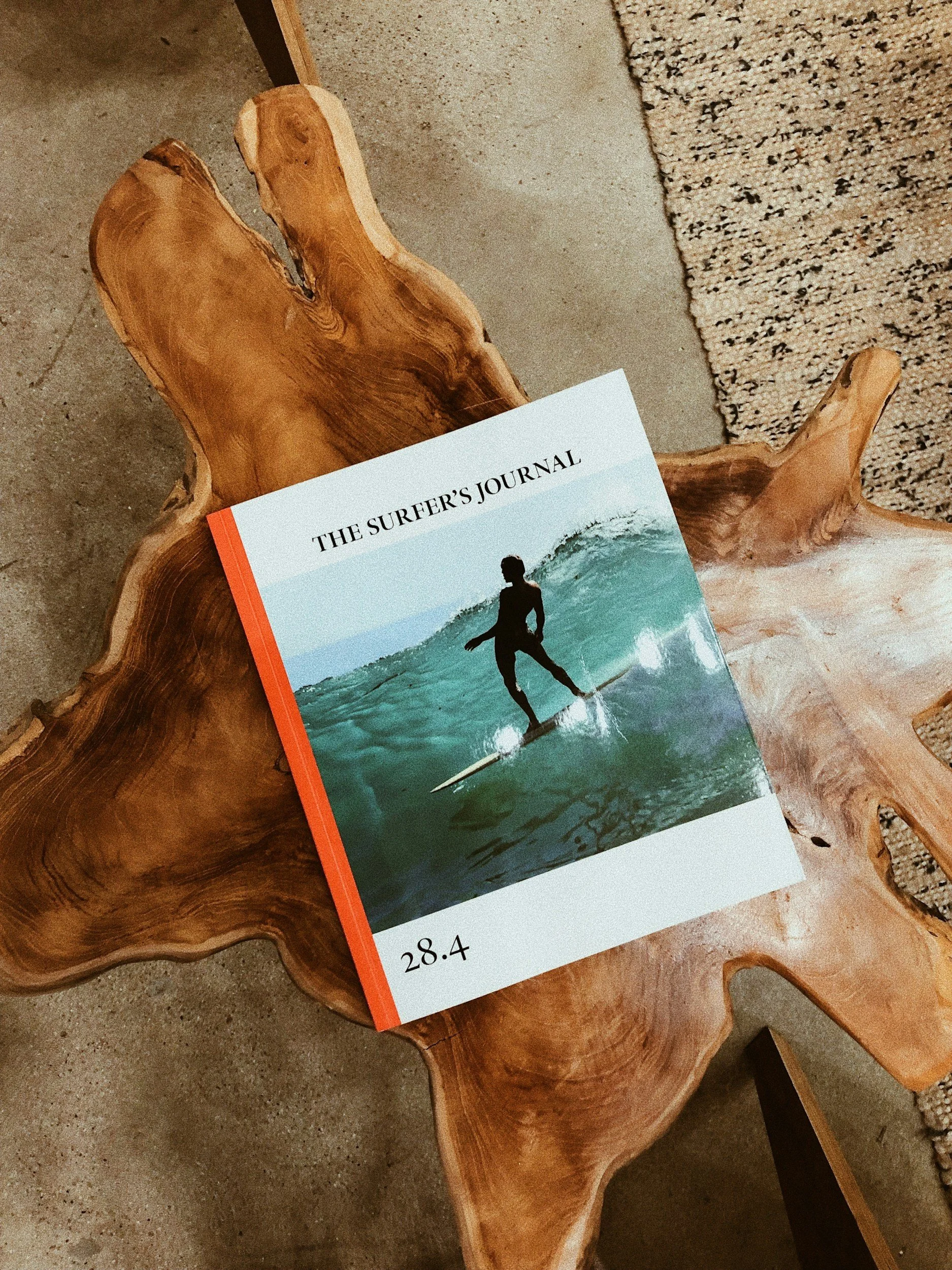 Surfer's journal on a wooden table at a coastal retreat.