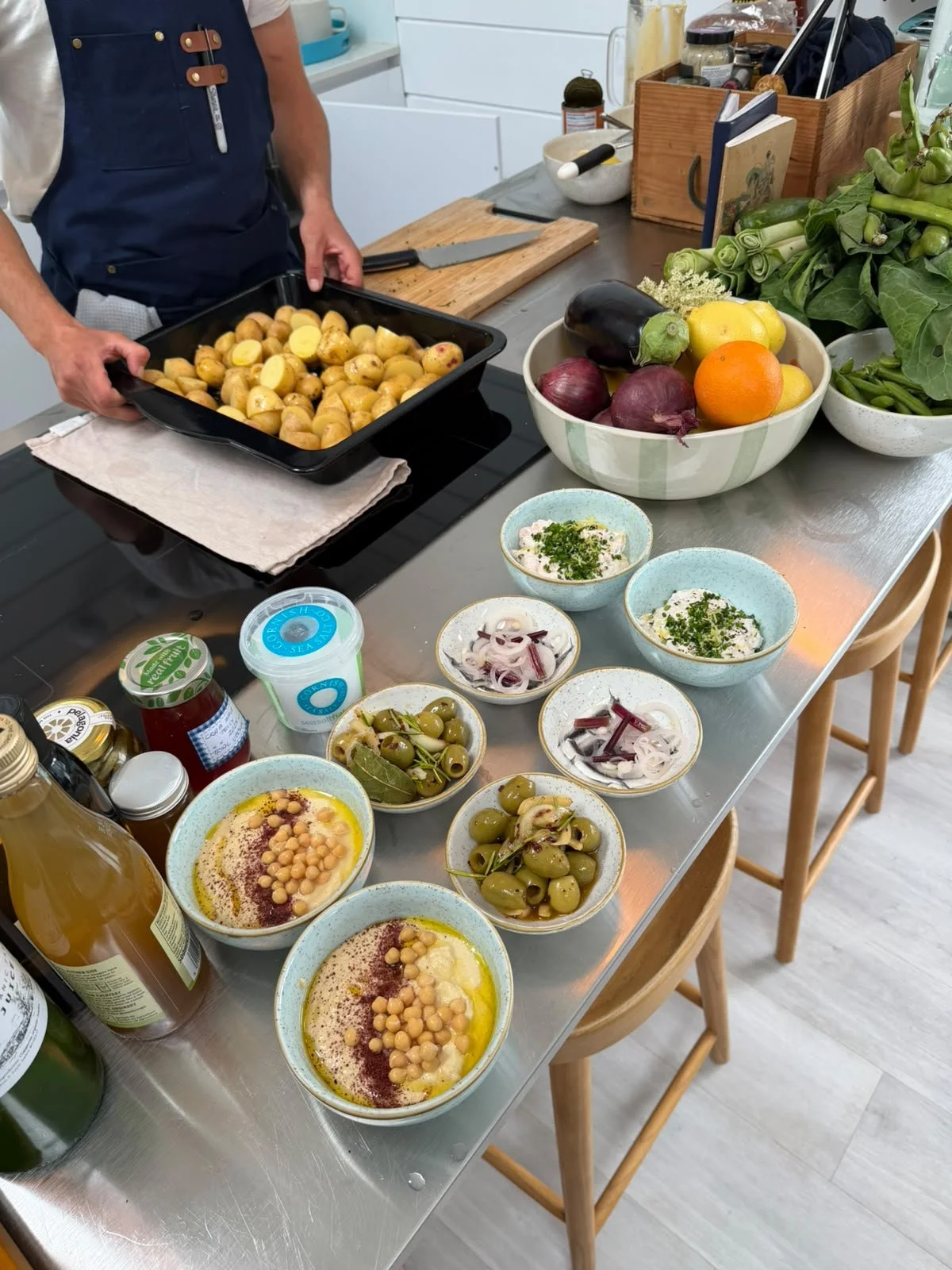 Shared dishes and fresh produce set out for dinner.