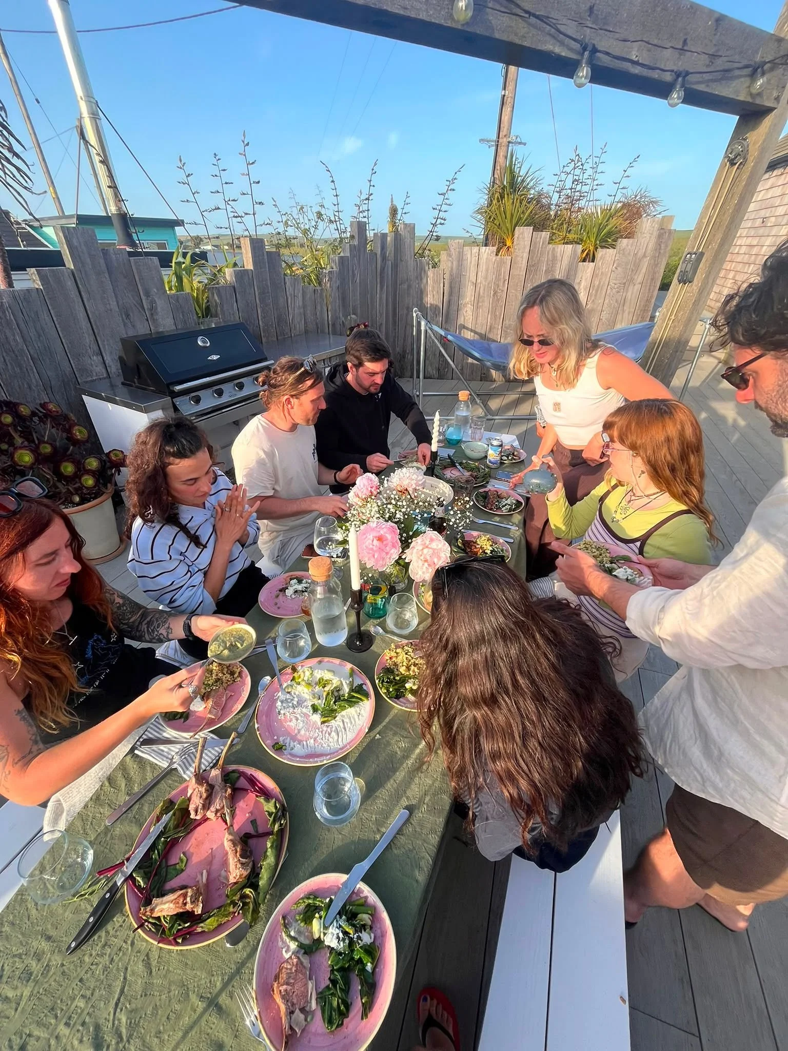 Guests sharing a long-table dinner at the retreat house.