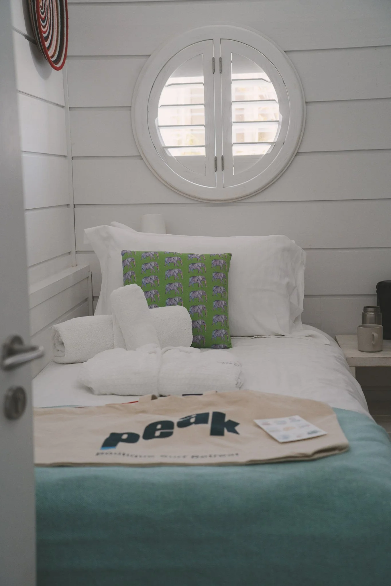 Boutique bedroom with a made bed at the Peak retreat house.