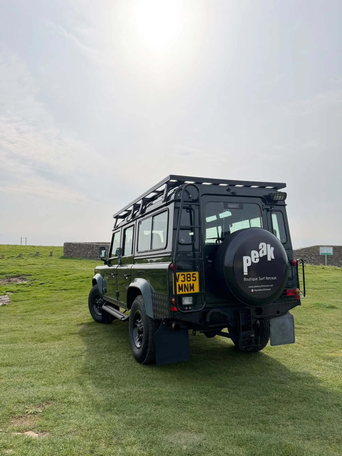 Peak surf retreat landrover defender parked near the coast