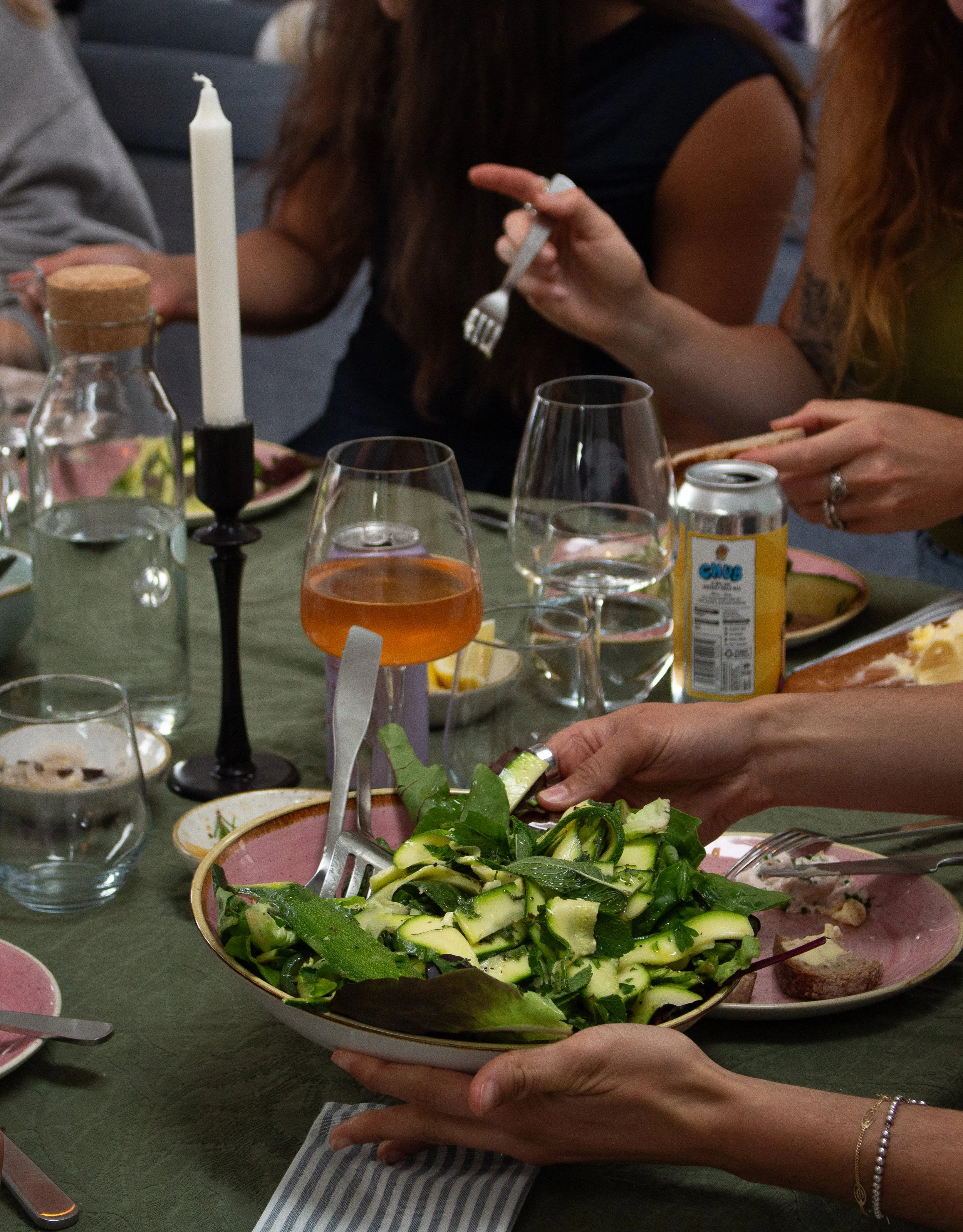 Shared dinner with seasonal salad at a Peak surf retreat in Cornwall.