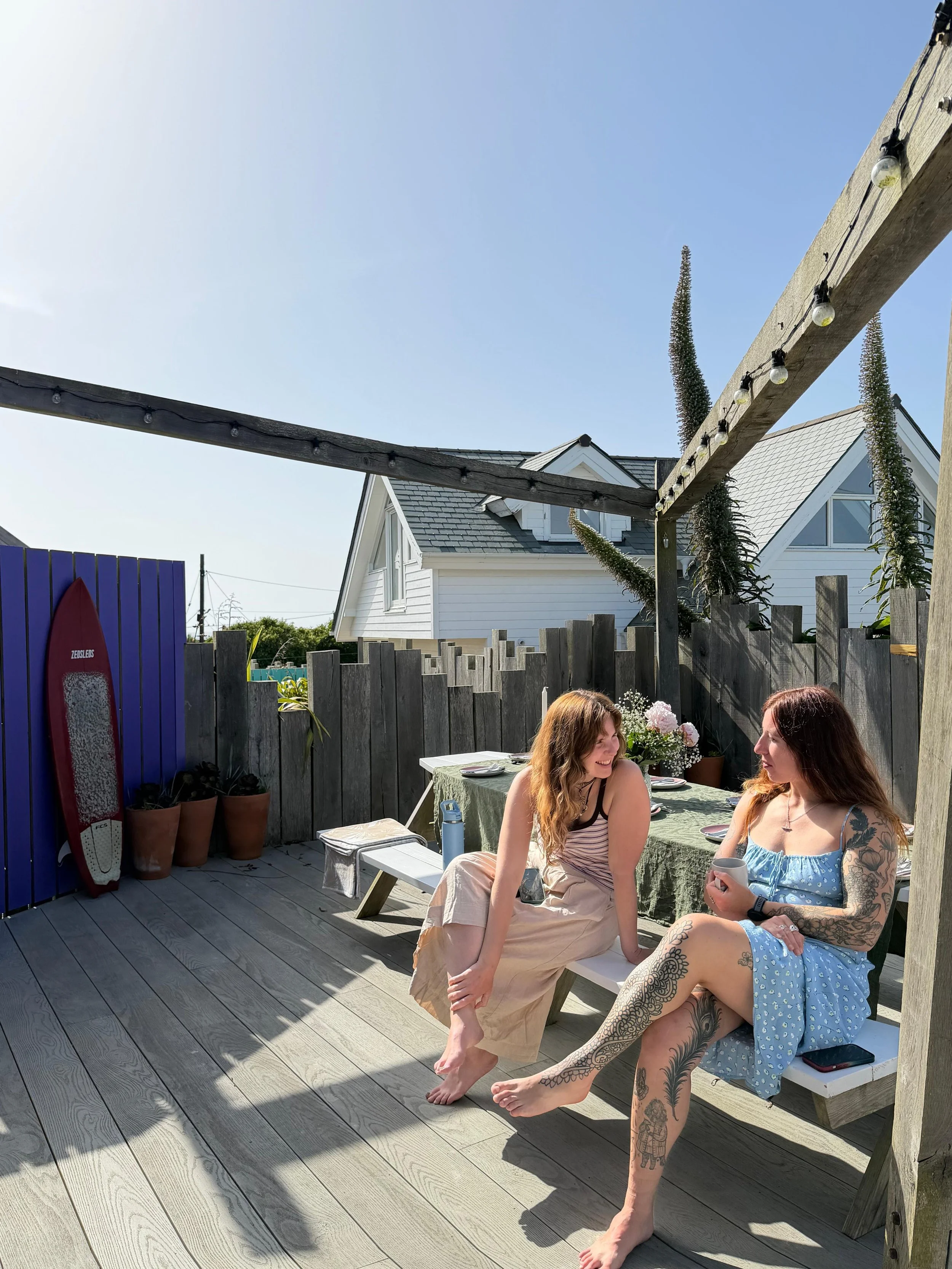 Guests relaxing on the outdoor terrace at the Peak retreat house.