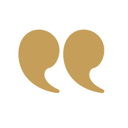 Two brown quotation marks on a black background