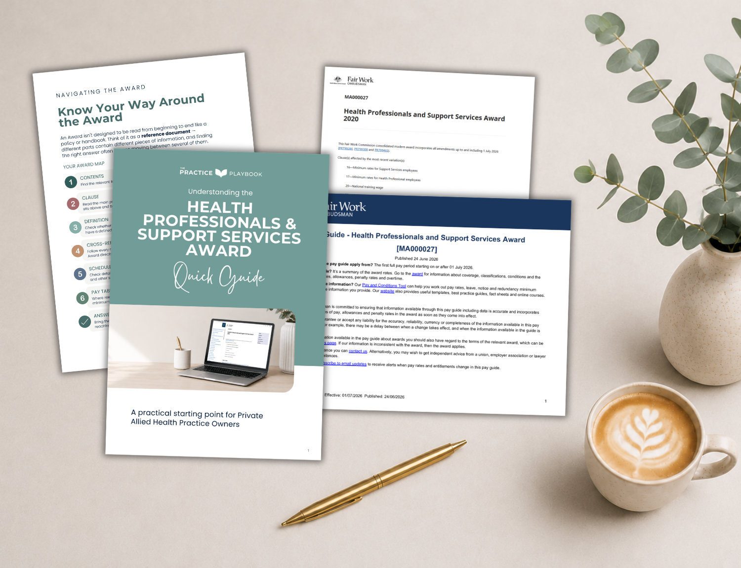 A collection of healthcare award guides and documents on a white desk, with a gold pen, a cup of coffee with latte art, a potted eucalyptus plant, and a cup of tea or coffee.