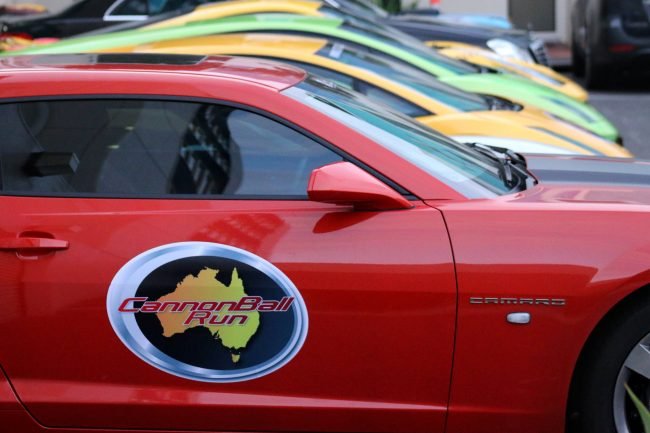 Red rally car with Cannonball Run Australia logo on the door
