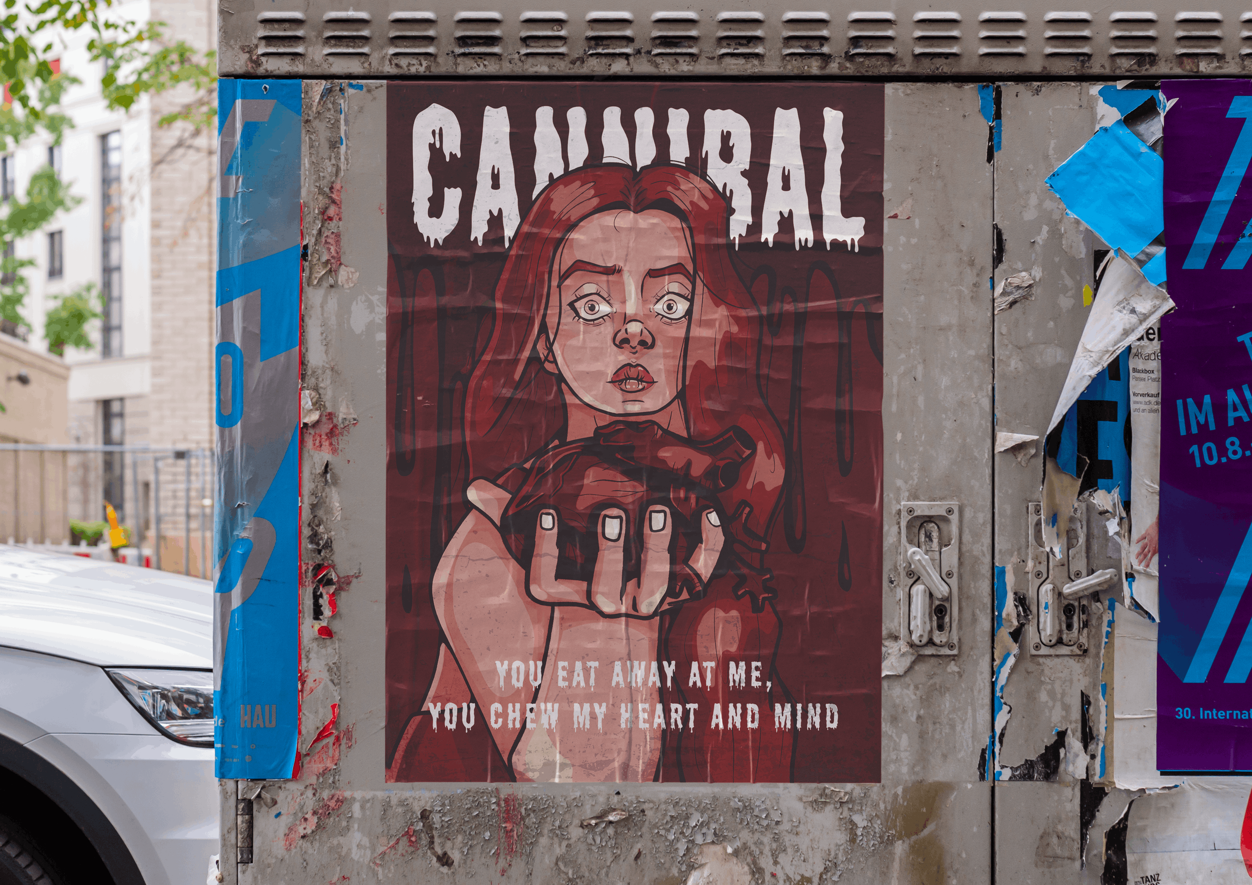 Street poster featuring an illustrated woman with long red hair and wide-open eyes. The woman appears to be biting her finger with a surprised or intense expression. Text above and below her reads: 'CANNIBAL' and 'YOU EAT AWAY AT ME
