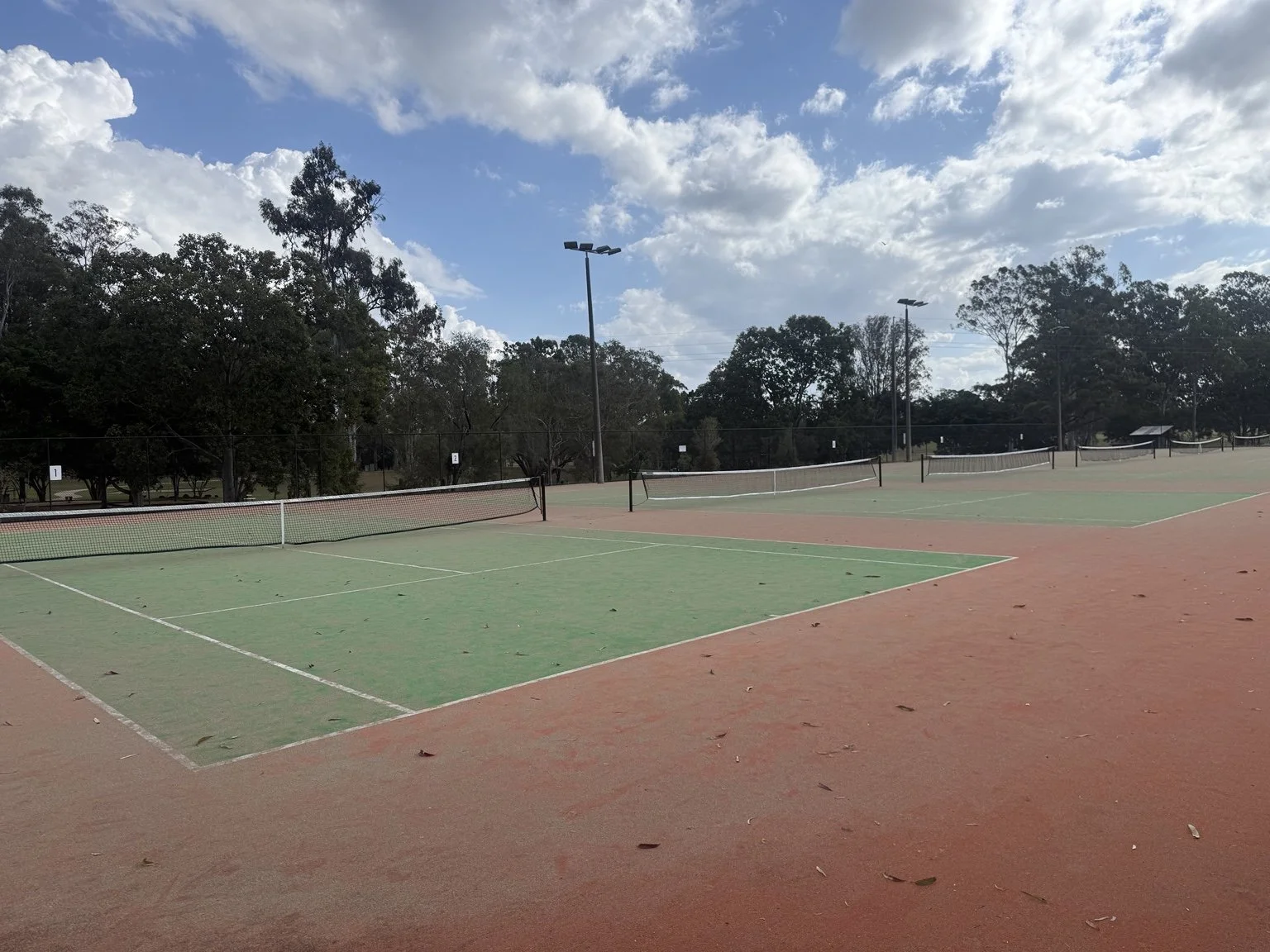 Outdoor tennis courts at Maryborough Tennis Association under a blue Queensland sky