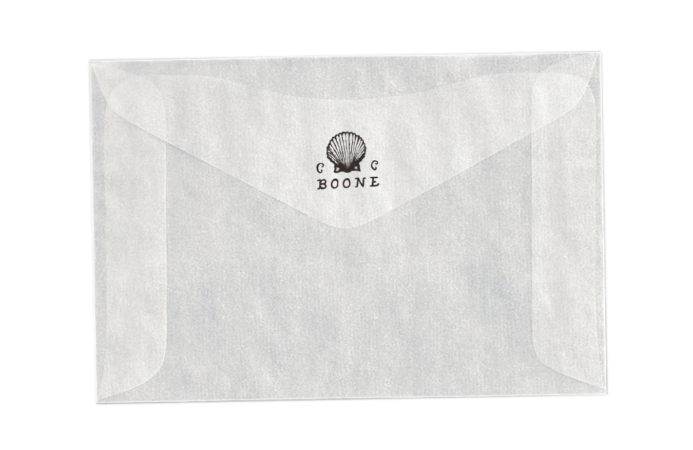 A translucent white envelope with a black shell logo and the word 'C C BOONE' printed underneath, set against a black background.