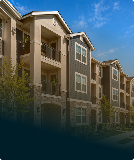 Exterior view of a modern multi-story apartment complex with balconies and large windows under a blue sky.