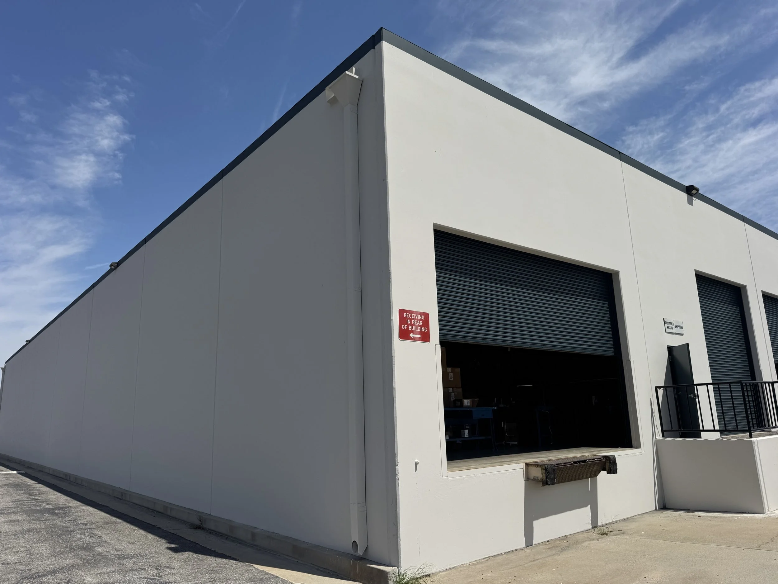 Industrial building with the exterior painted in a modern gray and accented with black.
