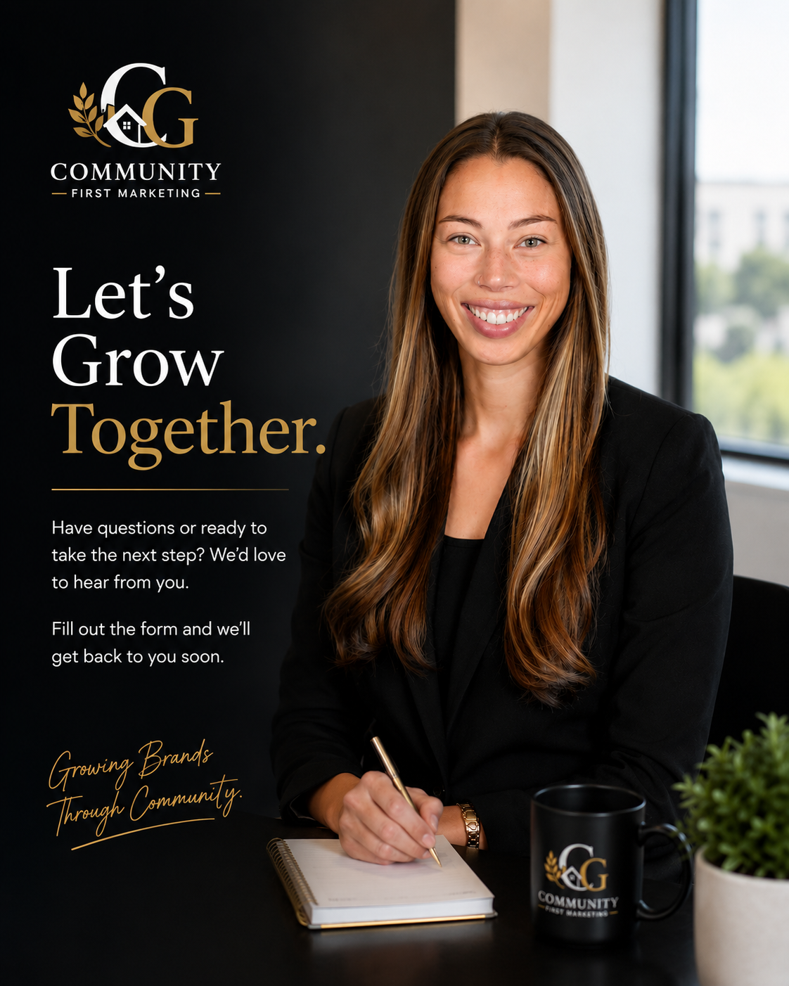 A woman with long brown hair smiling and sitting at a desk, holding a pen and a notebook. On the desk is a black coffee mug with a logo and a small potted plant. The background includes a window and a black and white wall with a logo and text for Community First Marketing.